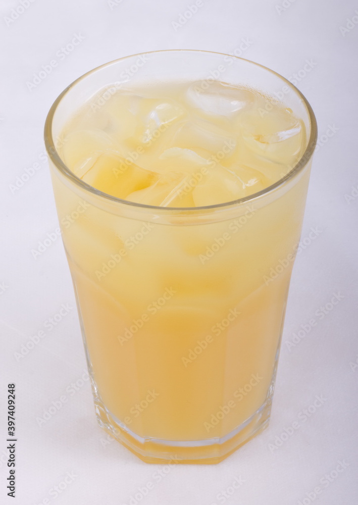 Pineapple juice with ice cubes in a glass Cup Pineapple juice with ice cubes in a glass Cup