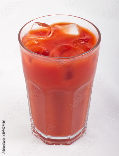 Tomato juice with ice cubes in a glass Cup