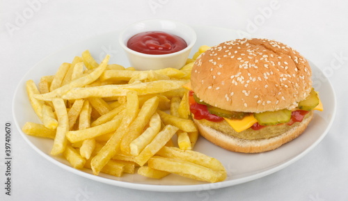 Hamburger with rustic potatoes and ketchup. Serving on a white plate