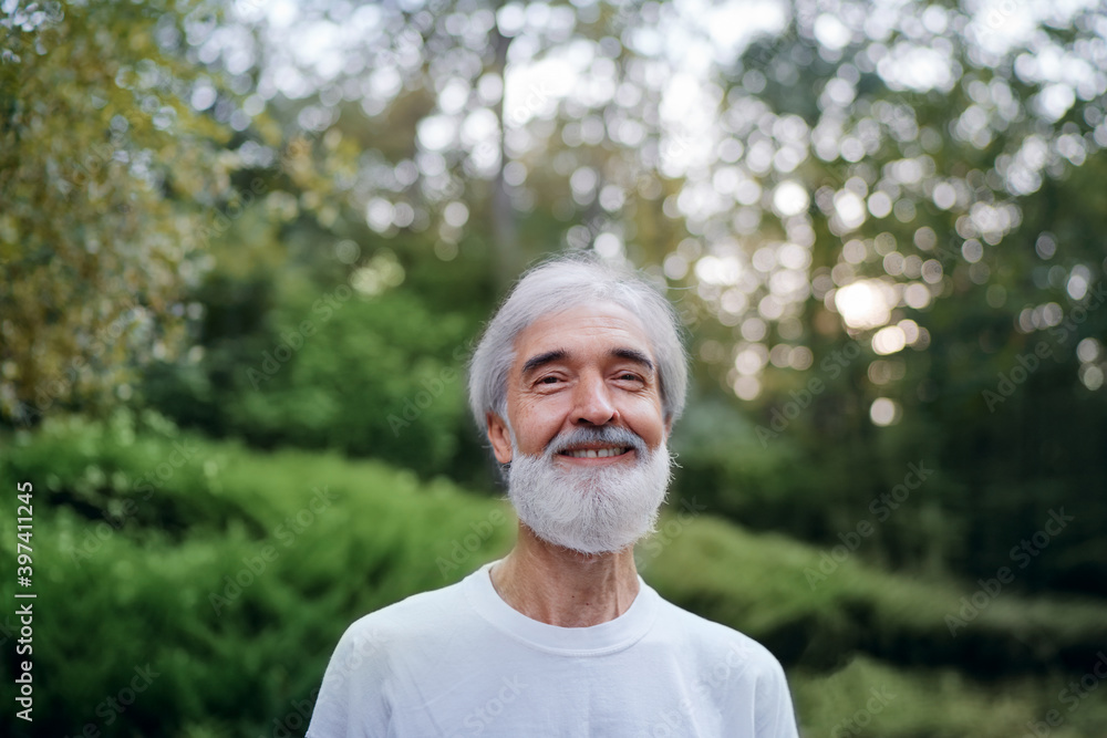 Outdoor portrait of handsome senior man with gray beard. Outdoor portrait of handsome senior man with gray beard.