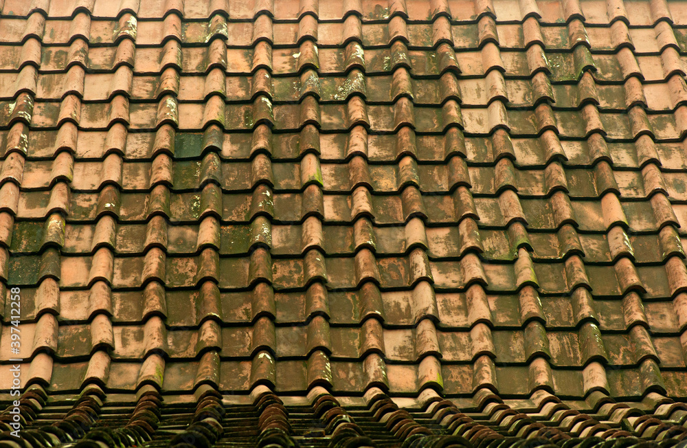 Vintage multi colored clay tiled roof in Java Island, Indonesia.