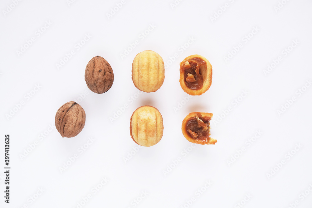 Creative mockup made of cookies in the shape of a nut and walnut. Flat lay. Food concept. Cookies on a white background.
Creative mockup made of cookies in the shape of a nut and walnut. Flat lay. Food concept. Cookies on a white background.