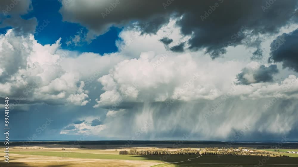 Rain Clouds Rain Sky Above Countryside Rural Field Landscape In Spring Summer Cloudy Day. Agricultural Field. Aerial View. Drone Lapse Hyperlapse Rain Clouds Rain Sky Above Countryside Rural Field Landscape In Spring Summer Cloudy Day. Agricultural Field. Aerial View. Drone Lapse Hyperlapse