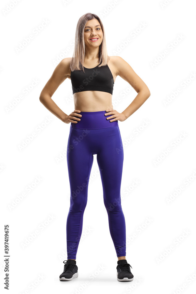 Full length portrait of a young blond woman in leggings and short sporty top Full length portrait of a young blond woman in leggings and short sporty top