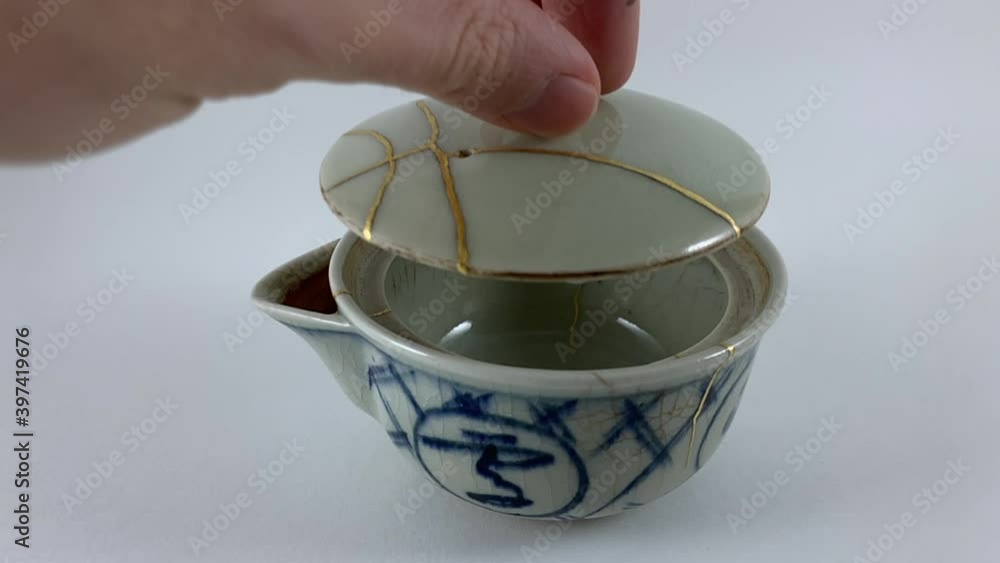 Antique broken Japanese tea pot repaired with gold kintsugi technique