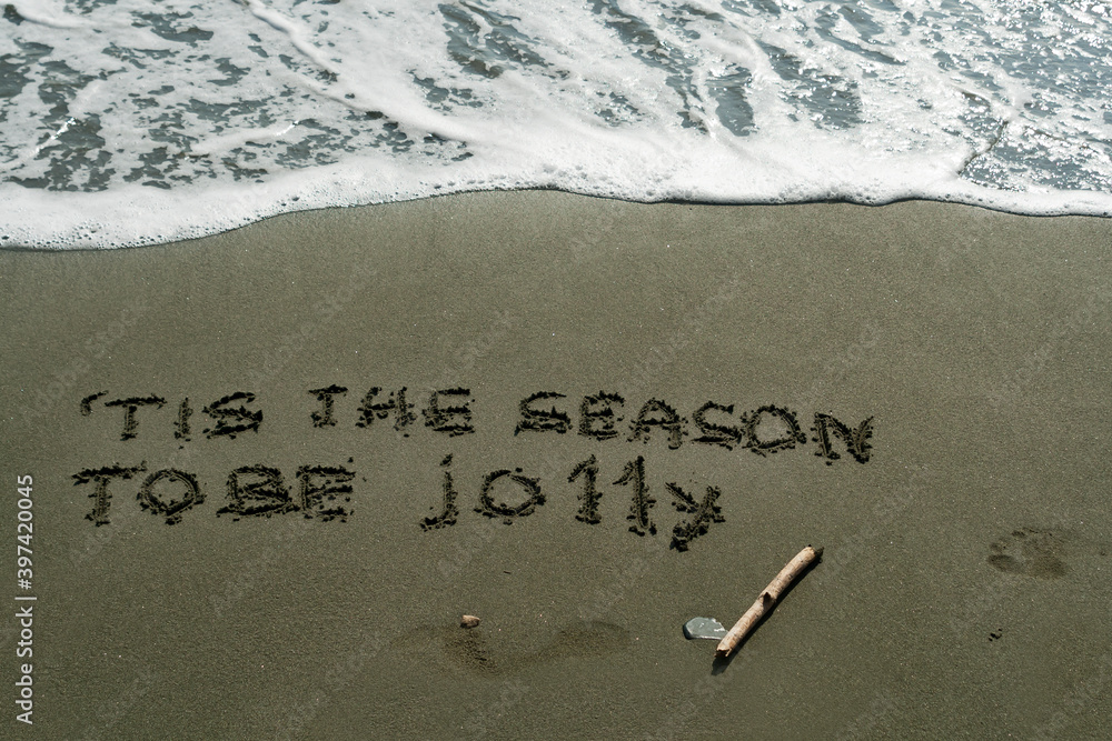 Fototapeta premium Line from Christmas carol on beach sand