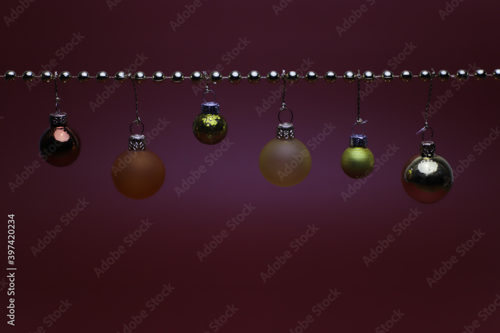Golden and orange Christmas balls on golden string Golden and orange Christmas balls on golden string