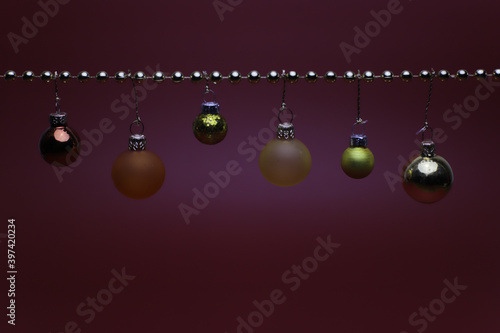 Golden and orange Christmas balls on golden string