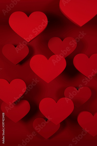 Volume hearts on red background. 3d rendering. Texture for valentine's day or wedding card. Vertical composition
