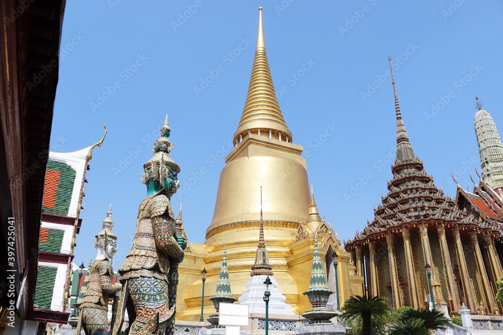 Temple of Emerald Buddha (Wat Phra Kaew) with Guardian Giants standing in Bangkok, Thailand. Is the grand palace of general tourists. Temple of Emerald Buddha (Wat Phra Kaew) with Guardian Giants standing in Bangkok, Thailand. Is the grand palace of general tourists.