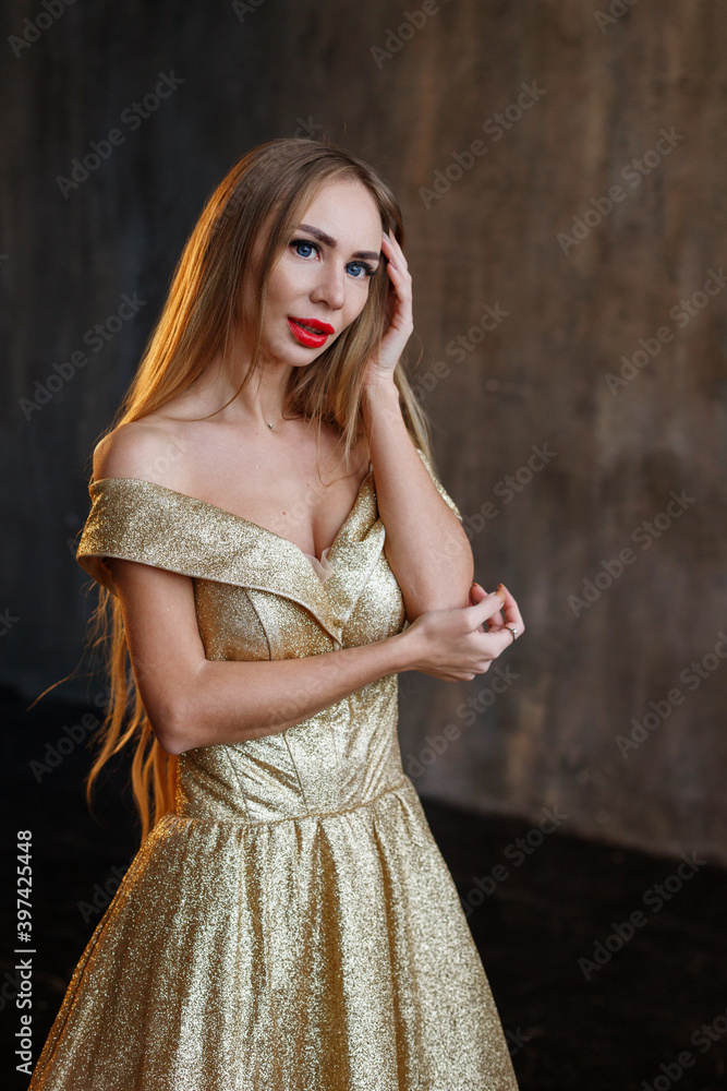 Fototapeta premium woman in gold shiny New Year's dress