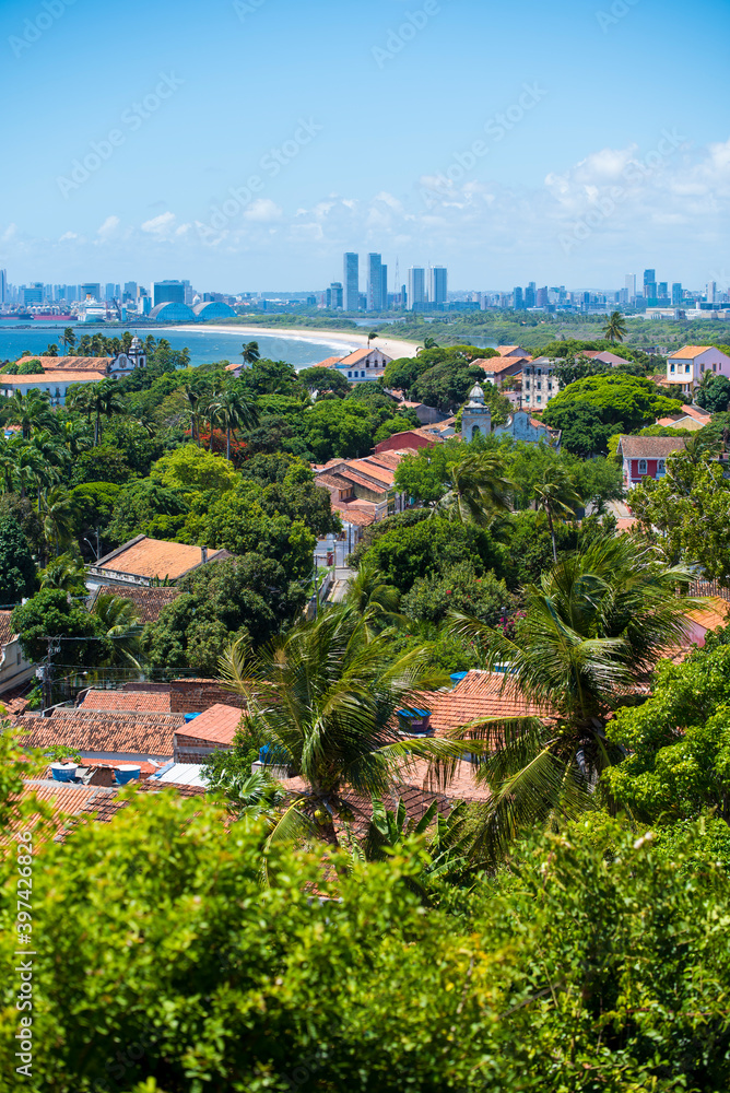 Brazilian old town of Olinda, aerial view with the city of Recife in the background, with the Atlantic ocean and bright blue sky.