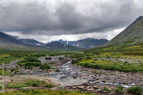 cold stream and mountain range on a summer day © Alx_Yago