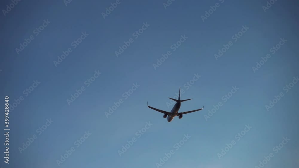 Silhouette of plane flying through evening sky. Fast airplane departing to place of destination in dusk. Concept of tourism, transport, vacation. Silhouette of plane flying through evening sky. Fast airplane departing to place of destination in dusk. Concept of tourism, transport, vacation.