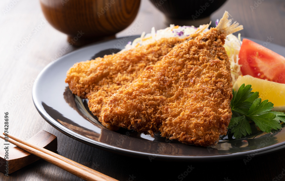 Fried horse mackerel served on a plate on a wooden background Fried horse mackerel served on a plate on a wooden background