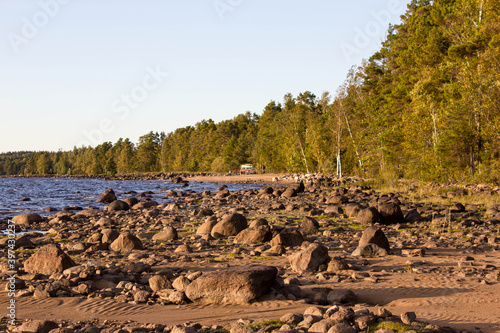 beautiful sunset on lake skagern in sweden, Lake seems like the sea. Many stones and coast full of sand photo