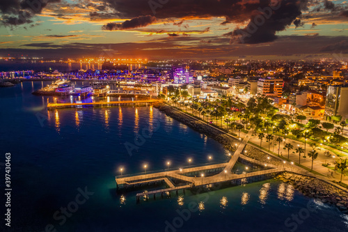 Republic of Cyprus. Panorama of evening Limassol from the air. The Mediterranean coast is lit up with lights. Travel to Cyprus. The coastline of Cyprus at night. Evening in Limassol.
