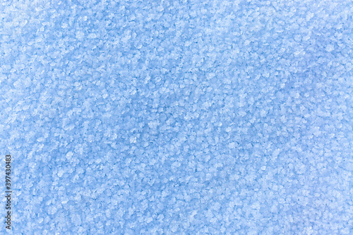 Winter snowy background with snow crystals. Copy space, horizontal, textured frozen surface, natural