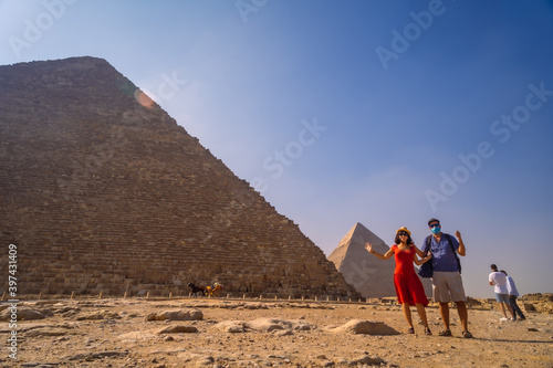 A couple in the pyramid of Cheops the largest pyramid. The pyramids of Giza the oldest funerary monument in the world. In the city of Cairo  Egypt