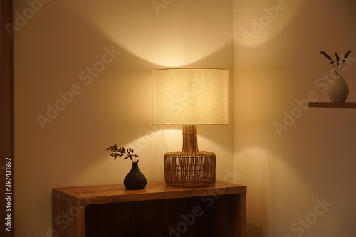 View of a cozy decorative corner with a table lamp spending warm light