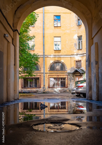 View of the yard and house through the arch of the entrance in Saint-Petersburg, Russia