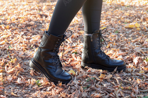 Woman wearing black boots in autumn