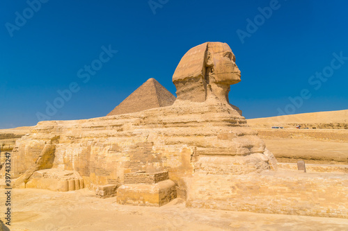 The Great Sphinx of Giza and in the background the Pyramids of Giza, the oldest Funerary monument in the world. In the city of Cairo, Egypt