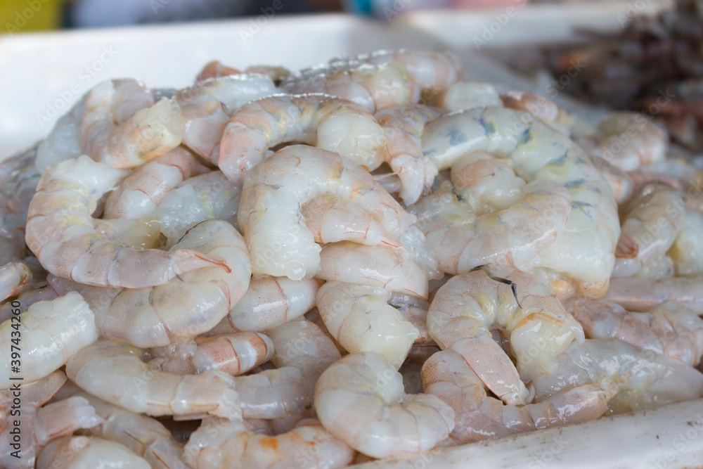 Fresh prawns without the head on a tray in the fish market. Food very widespread in coastal cities.Raw Shrimp.Fresh shelled prawns on the fish market. close-up photo of ocean food. Fish Food. Fresh prawns without the head on a tray in the fish market. Food very widespread in coastal cities.Raw Shrimp.Fresh shelled prawns on the fish market. close-up photo of ocean food. Fish Food.