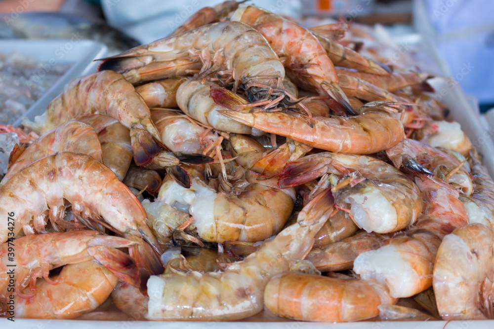 Fresh prawns without the head on a tray in the fish market. Food very widespread in coastal cities.Raw Shrimp.