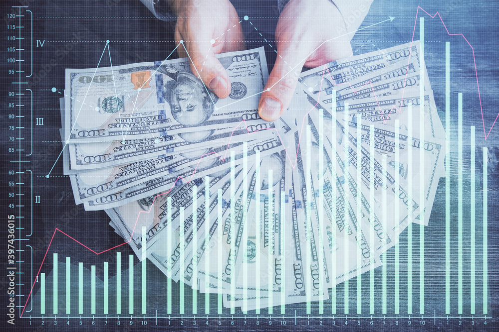 Multi exposure of financial graph drawing hologram and USA dollars bills and man hands. Analysis concept. Multi exposure of financial graph drawing hologram and USA dollars bills and man hands. Analysis concept.