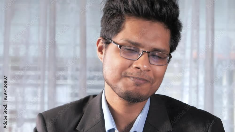 Asian Businessman In a video conference looking at camera Asian Businessman In a video conference looking at camera