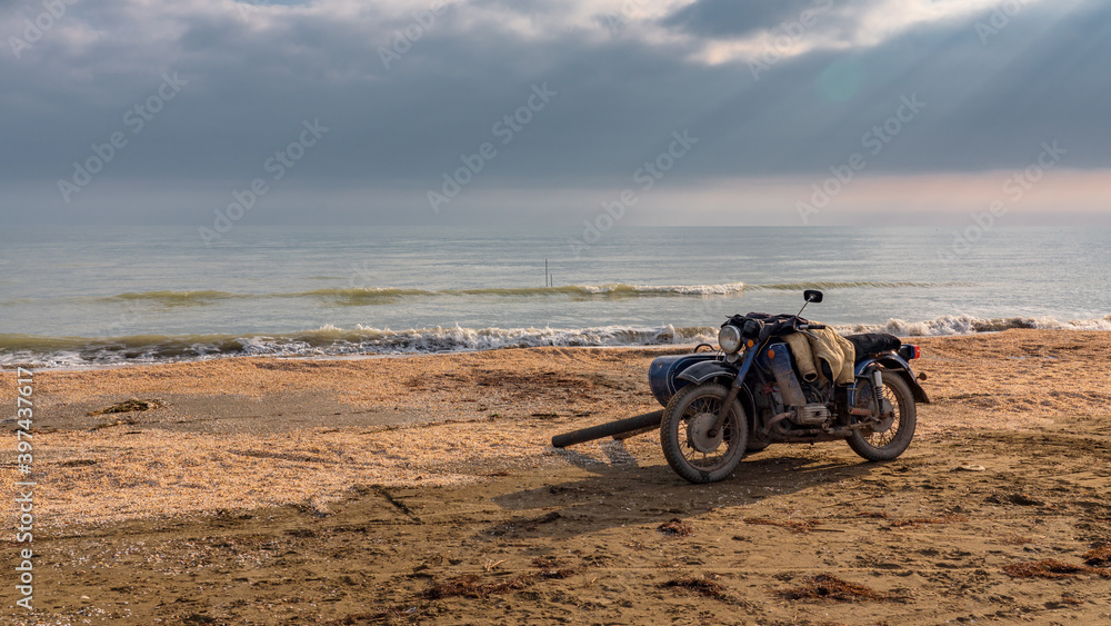 Old motorcycle by the sea shore