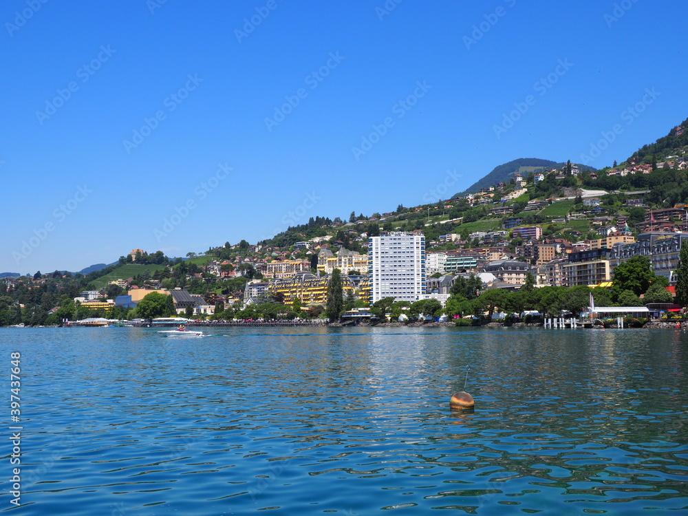 Scenery of Lake Geneva and european Montreux city in canton Vaud in Switzerland, clear blue sky in 2017 warm sunny summer day on July.