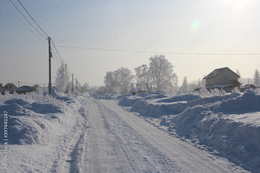 winter in Siberia snow white road in snowdrifts beautiful houses in the village of rime winter in Siberia snow white road in snowdrifts beautiful houses in the village of rime