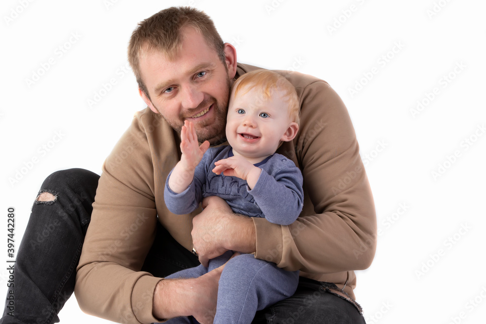 Over white background happy dad with one-year-old toddler smiling and looking at the camera.