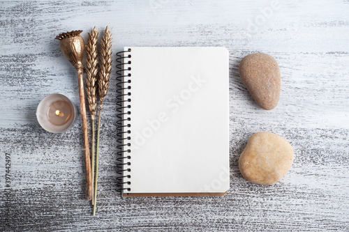 Empty open notebook and dry flowers