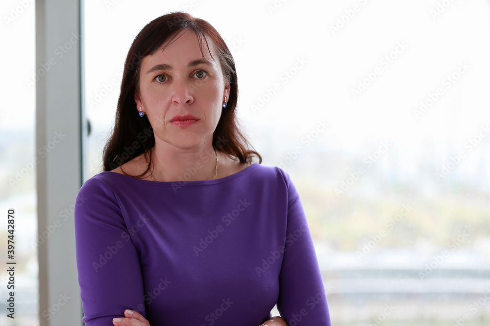 Fototapeta premium Portrait of a middle-aged woman in a purple dress.