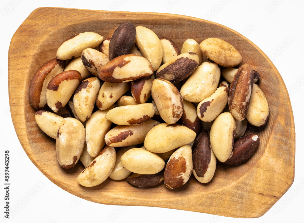 brazilian nuts in a wooden rustic bowl isolated on white brazilian nuts in a wooden rustic bowl isolated on white