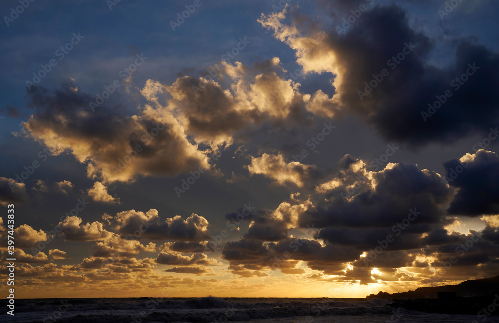 Sunset during sea storm