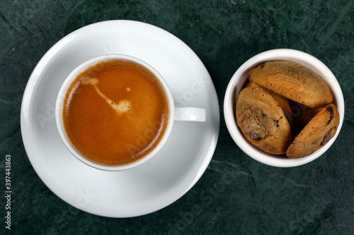 White cup of Turkish coffee "espresso" and cookies on the wooden table, top view