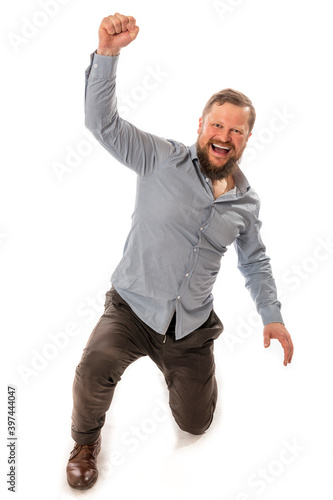 Joyful bearded man in shirt is happy to win photo