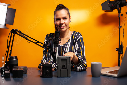 Testing portable battery for videographers camera in podcast. Professional videography gear review by content creator new media star influencer on social media. photo