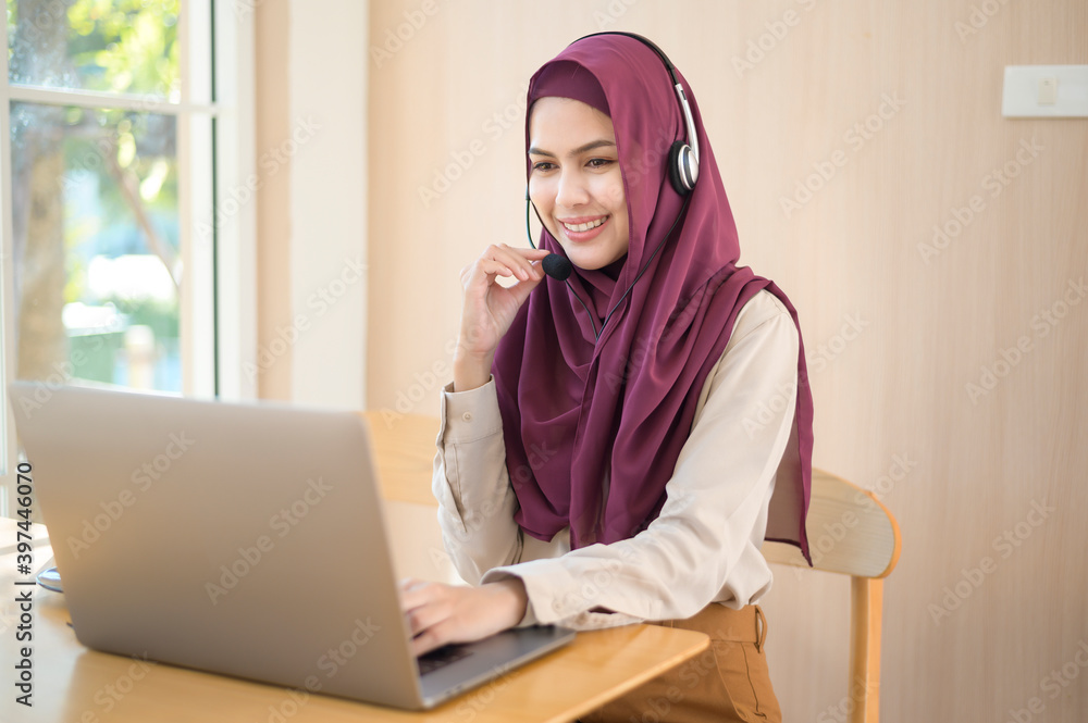 Muslim operator woman in headset using computer answering customer call in office, Customer service concept Muslim operator woman in headset using computer answering customer call in office, Customer service concept