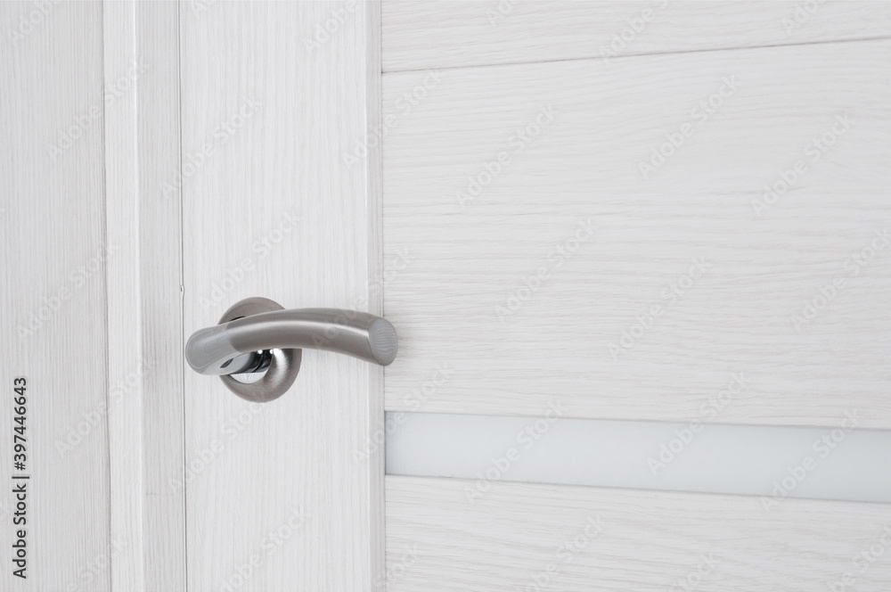 Metallic door knob on a home wooden door Metallic door knob on a home wooden door