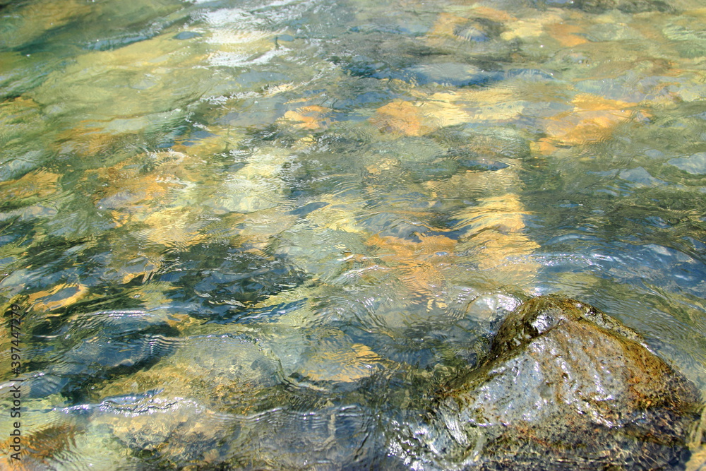 abstract pure water with colourfull rock inside