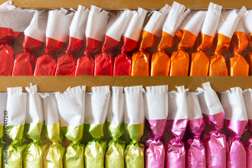 two sets of candies in colored tinfoil for a Christmas tree, candies wrapped in colored foil 