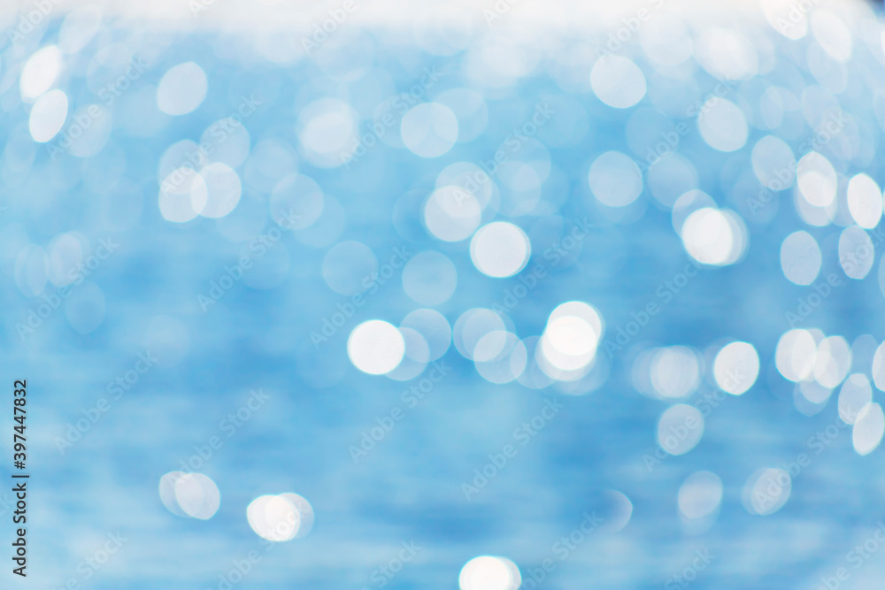Delicate blue texture bokeh sea. Summer background. Blurry blue bokeh glare on the water on a sunny day. Concept travel. Delicate blue texture bokeh sea. Summer background. Blurry blue bokeh glare on the water on a sunny day. Concept travel.