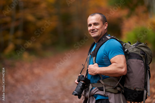 Nature photographer shooting fall scene in the forest