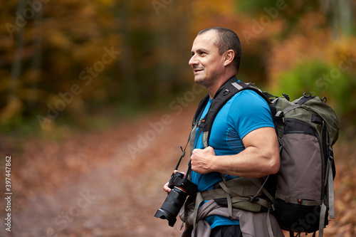 Nature photographer shooting fall scene in the forest