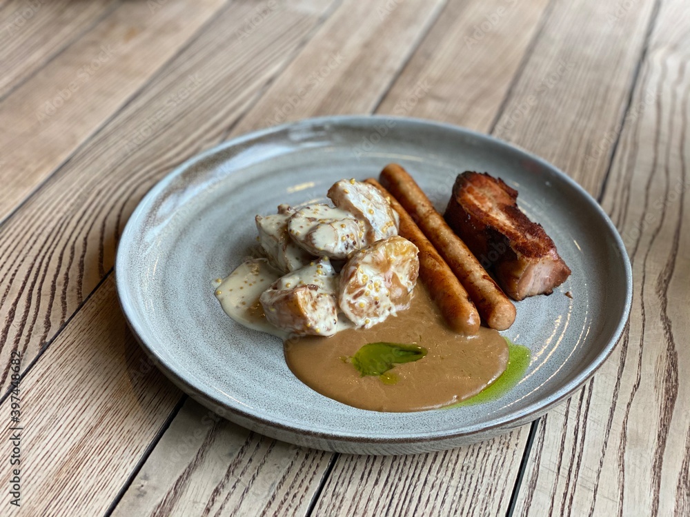 meat, sausages and potatoes with sauce meat, sausages and potatoes with sauce